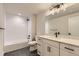 Modern bathroom with sleek black hardware, tiled shower and floors, plus vanity, creating a stylish, functional space at 8926 S Rome Ct, Aurora, CO 80016