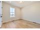 Bright bedroom with hardwood floors and a large window with views of the neighborhood at 8926 S Rome Ct, Aurora, CO 80016