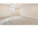 Neutral bedroom features carpet and window for natural light, offering a cozy and adaptable space at 8926 S Rome Ct, Aurora, CO 80016