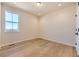Bright bedroom with hardwood floors and a large window with views of the neighborhood at 8926 S Rome Ct, Aurora, CO 80016