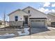 Charming two-story home featuring stone accents, a two-car garage, and a well-maintained lawn at 8926 S Rome Ct, Aurora, CO 80016