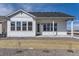 Back exterior showcasing a bright house with ample windows and a well-maintained yard at 8926 S Rome Ct, Aurora, CO 80016