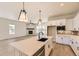 Modern kitchen with white cabinets, stainless steel appliances, and an island with a black sink at 8926 S Rome Ct, Aurora, CO 80016