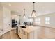 Bright kitchen features a large island with a black sink and stainless steel appliances at 8926 S Rome Ct, Aurora, CO 80016