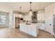 Modern kitchen featuring white cabinetry, a large island, and stylish pendant lighting at 8926 S Rome Ct, Aurora, CO 80016