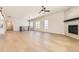Open-concept living area boasting a cozy fireplace, hardwood floors, and plenty of natural light at 8926 S Rome Ct, Aurora, CO 80016