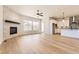 Open-concept living area boasting a cozy fireplace, hardwood floors, and plenty of natural light at 8926 S Rome Ct, Aurora, CO 80016