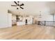 Open-concept living area boasting a cozy fireplace, hardwood floors, and plenty of natural light at 8926 S Rome Ct, Aurora, CO 80016