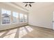 Bright main bedroom with hardwood floors, a ceiling fan, and natural light from a window at 8926 S Rome Ct, Aurora, CO 80016