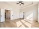 Bright main bedroom with hardwood floors, a ceiling fan, with a bathroom and a closet at 8926 S Rome Ct, Aurora, CO 80016