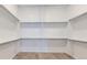 Walk-in closet provides ample storage with multiple shelves and rods, blending functionality with clean design at 8926 S Rome Ct, Aurora, CO 80016