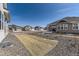 Landscaped yard with gravel and newly planted grass, blending nature with an organized space at 8926 S Rome Ct, Aurora, CO 80016
