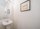 Bathroom with pedestal sink, framed artwork, and neutral paint at 22023 E 38Th Pl, Aurora, CO 80019