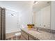 Bright bathroom with a tub shower combo and a large mirror above a granite countertop sink at 22023 E 38Th Pl, Aurora, CO 80019