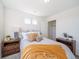 Bright bedroom featuring neutral decor, comfortable bedding, and natural light streaming through multiple windows at 22023 E 38Th Pl, Aurora, CO 80019