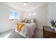 Bright bedroom featuring neutral decor, comfortable bedding, and natural light streaming through a large window at 22023 E 38Th Pl, Aurora, CO 80019