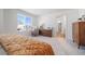 Bright bedroom featuring a large window, cozy chair, and neutral decor perfect for relaxation and comfort at 22023 E 38Th Pl, Aurora, CO 80019