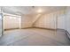 Spacious two-car garage with concrete floor and side door at 22023 E 38Th Pl, Aurora, CO 80019