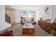 Cozy living room with comfortable seating, a stylish rug, and lots of natural light at 22023 E 38Th Pl, Aurora, CO 80019