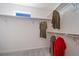 Organized walk-in closet with ample hanging space and a small window providing natural light at 22023 E 38Th Pl, Aurora, CO 80019