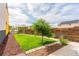 Expansive backyard with green lawn, patio area, and mature trees at 6892 Juniper Ct, Arvada, CO 80007