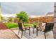 Relaxing backyard features a patio with outdoor seating and lush green lawn at 6892 Juniper Ct, Arvada, CO 80007