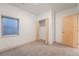 Basement bedroom featuring carpet floors, neutral walls, and a closet with a folding door at 6892 Juniper Ct, Arvada, CO 80007
