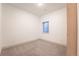Cozy basement bedroom with carpet floors, neutral walls, a small window, and a door at 6892 Juniper Ct, Arvada, CO 80007