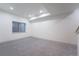 Spacious basement area with gray carpet, a small window, and recessed ceiling lights at 6892 Juniper Ct, Arvada, CO 80007