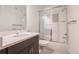 Modern bathroom featuring a shower/tub combo and a vanity with a sleek countertop at 6892 Juniper Ct, Arvada, CO 80007