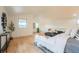 Bright bedroom featuring hardwood floors, natural light, and tastefully decorated with neutral tones at 6892 Juniper Ct, Arvada, CO 80007