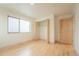 Bright bedroom featuring a closet, natural light, and hardwood floors at 6892 Juniper Ct, Arvada, CO 80007