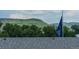 Community's mountain views featuring a blue flag with community name, offering a tranquil and scenic setting at 6892 Juniper Ct, Arvada, CO 80007