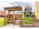 Charming front yard with lush green lawn and wooden pergola walkway at 6892 Juniper Ct, Arvada, CO 80007