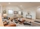 Bright living room with high ceilings, modern decor, and hardwood floors at 6892 Juniper Ct, Arvada, CO 80007