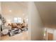 Open concept living room with hardwood floors, stylish furniture, and an abundance of natural light at 6892 Juniper Ct, Arvada, CO 80007