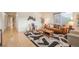 Bright living room featuring hardwood floors, modern decor, and a cozy seating area at 6892 Juniper Ct, Arvada, CO 80007