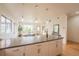 Bright and open living space with a dining area and kitchen island, perfect for entertaining at 6892 Juniper Ct, Arvada, CO 80007