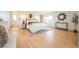 Serene primary bedroom with hardwood floors, a window for natural light, and a calming neutral palette at 6892 Juniper Ct, Arvada, CO 80007