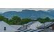 Rooftop solar panels offer eco-friendly, sustainable energy, complemented by a scenic mountain backdrop at 6892 Juniper Ct, Arvada, CO 80007