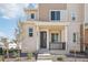 Modern two-story townhome with light brick exterior and covered porch at 24501 E 41St Ave, Aurora, CO 80019