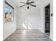 Bright dining area features modern ceiling fan, wood-look flooring, and natural light from a large window at 7995 E Mississippi Ave # J1, Denver, CO 80247