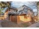 Townhouse with a wood fence and a sloped roof at 7995 E Mississippi Ave # J1, Denver, CO 80247