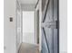 Hallway with carpet and a gray sliding barn door for the bathroom or bedroom at 7995 E Mississippi Ave # J1, Denver, CO 80247