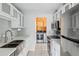 Bright kitchen featuring stainless steel appliances, modern cabinets, and a view into the laundry area at 7995 E Mississippi Ave # J1, Denver, CO 80247