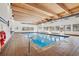 Indoor pool with blue tile and a wooden ceiling, surrounded by windows at 7995 E Mississippi Ave # J1, Denver, CO 80247