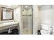 Compact bathroom showcasing a granite vanity, glass-enclosed shower, and tiled accents at 10601 Chadsworth Ln, Highlands Ranch, CO 80126