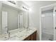 Bathroom featuring double sinks, granite countertops, and a view of the tub at 10601 Chadsworth Ln, Highlands Ranch, CO 80126