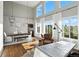 Spacious dining room filled with natural light, showcasing a large dining table, a comfortable chair, and hardwood floors at 10601 Chadsworth Ln, Highlands Ranch, CO 80126