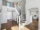 Elegant foyer with hardwood floors, curved staircase, and natural light streaming in at 10601 Chadsworth Ln, Highlands Ranch, CO 80126